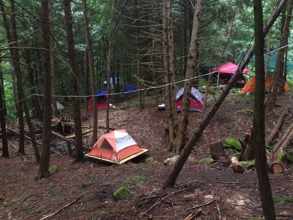 Flamneau2016 Tents pitched in the woods, including one on a raised wooded platform.