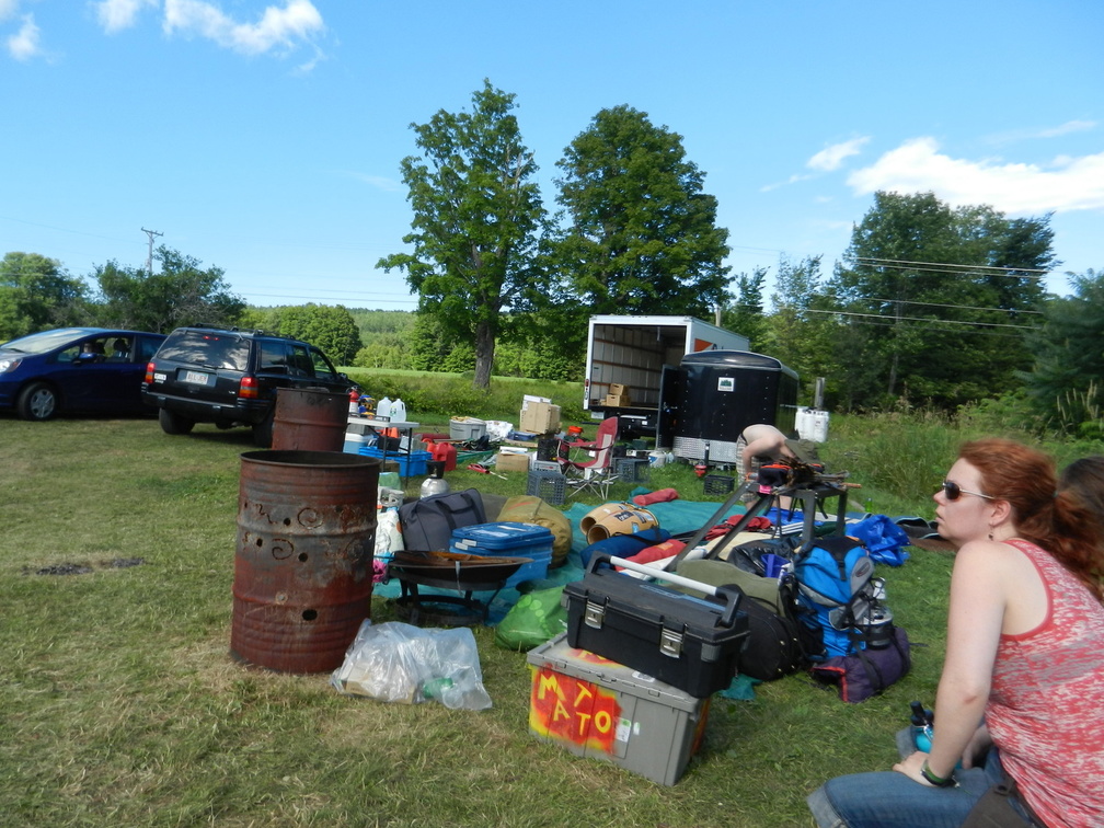 ??Peopleand Stuff 2012C A volunteer sits by a pile of gear near Upper Parking.