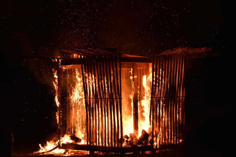 Rumi2017f A wooden structure burns at nighttime.